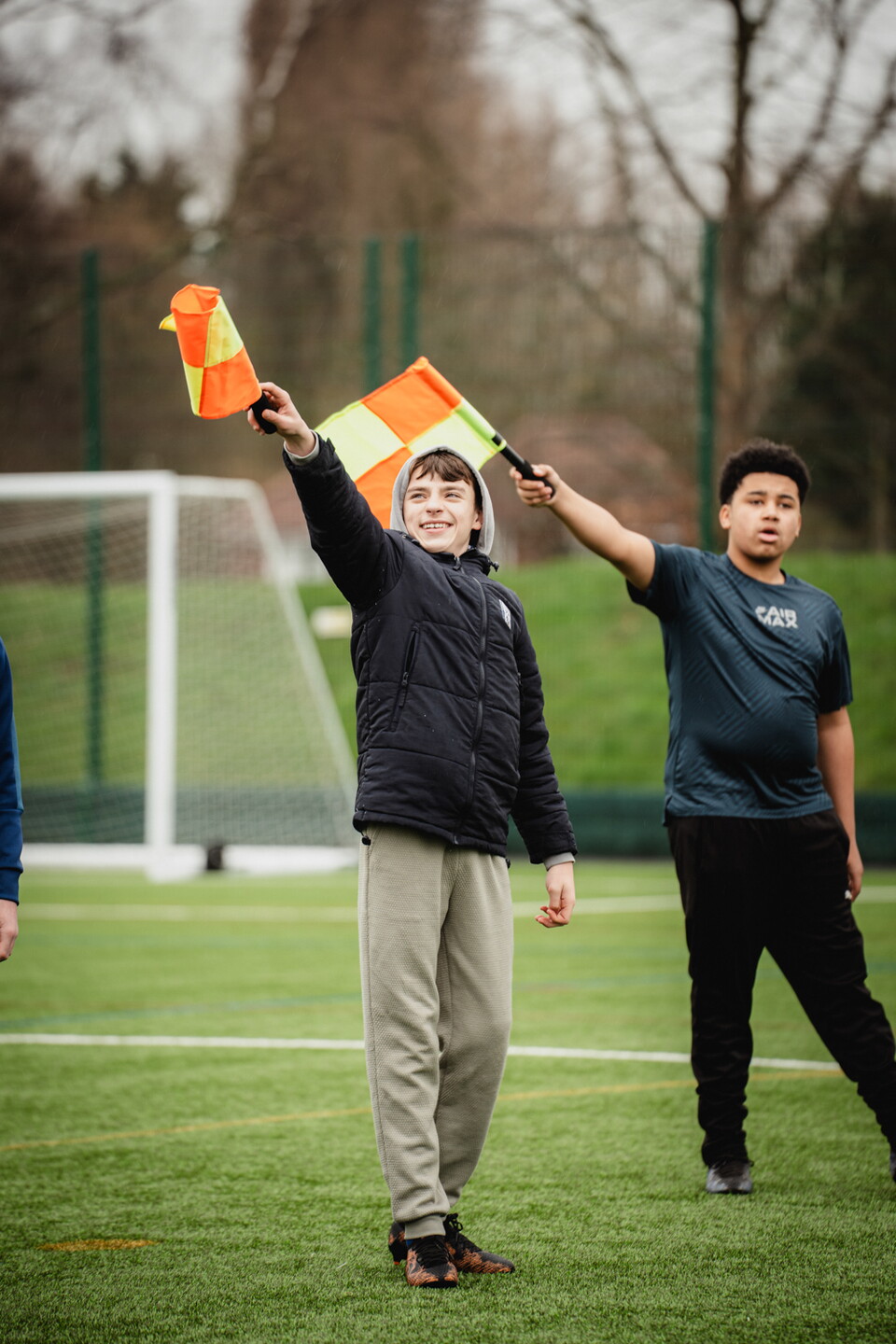 Particpants holding up referee assistants flags.