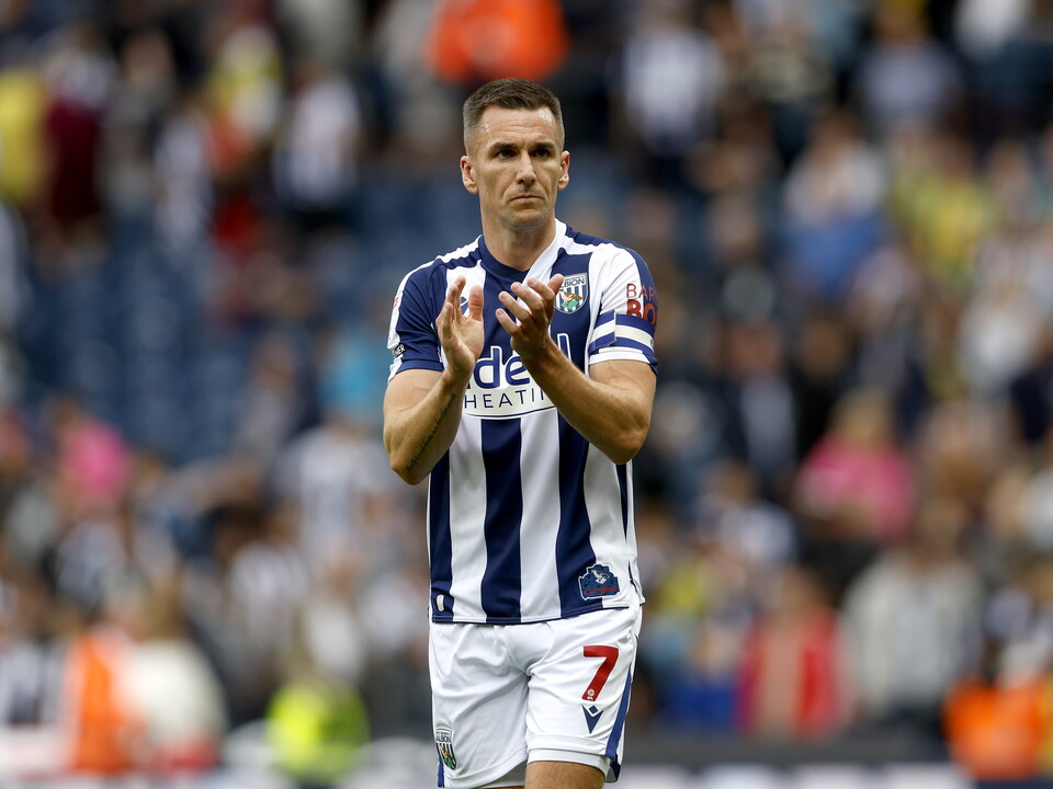 An image of Jed Wallace applauding Albion fans