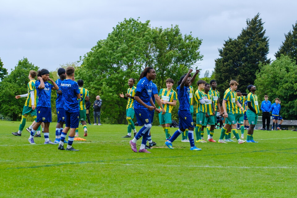 Teams standing on the halfway line during penalty shoot-out