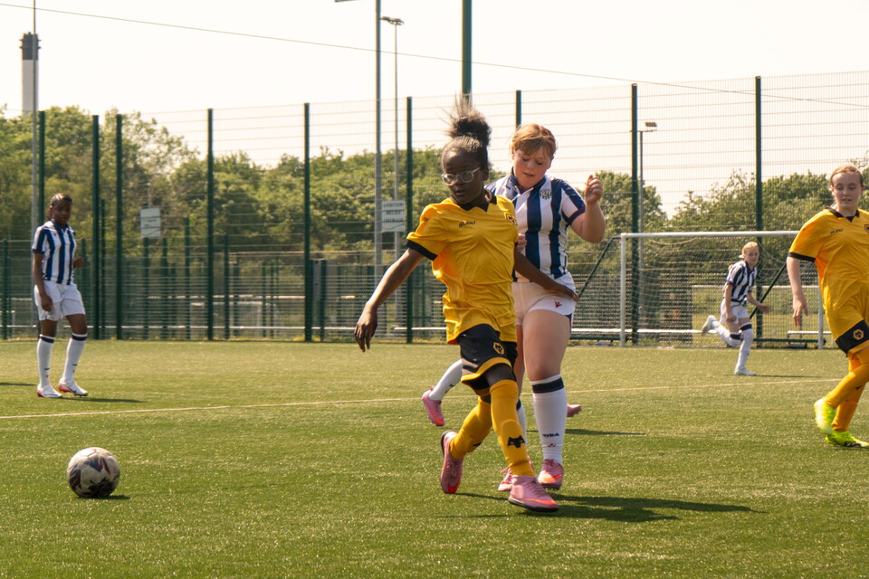 Wolves and Albion youth players chasing the ball