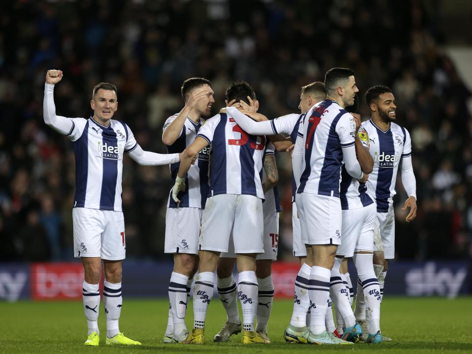 An image of Okay Yokuslu celebrating with his teammates after scoring against Preston