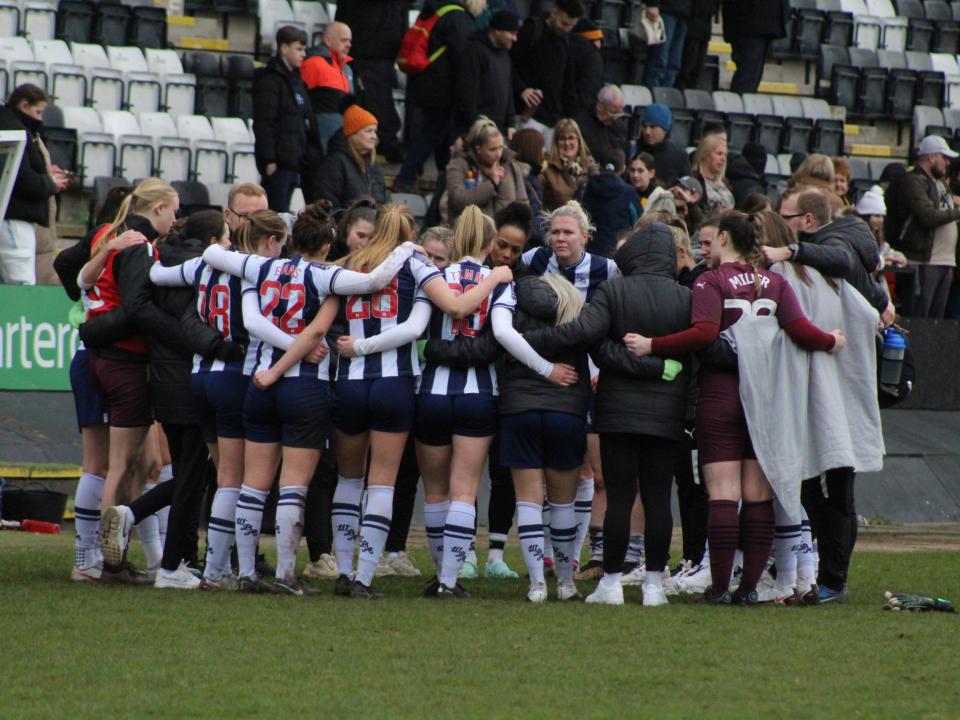 An image of the Albion Women squad in a huddle