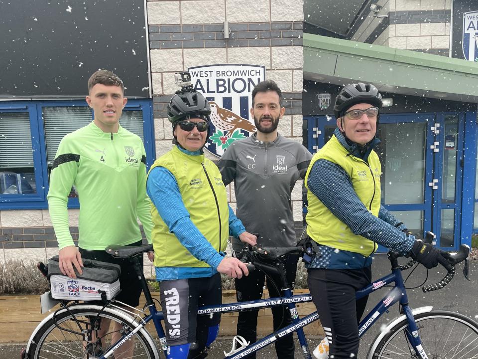 Dara O'Shea, Carlos Corberán and "Blind Dave" with a bicycle 