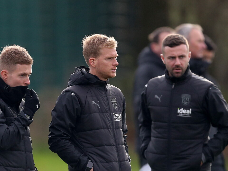 A photo of U18s boss Leigh Downing standing in the dugout