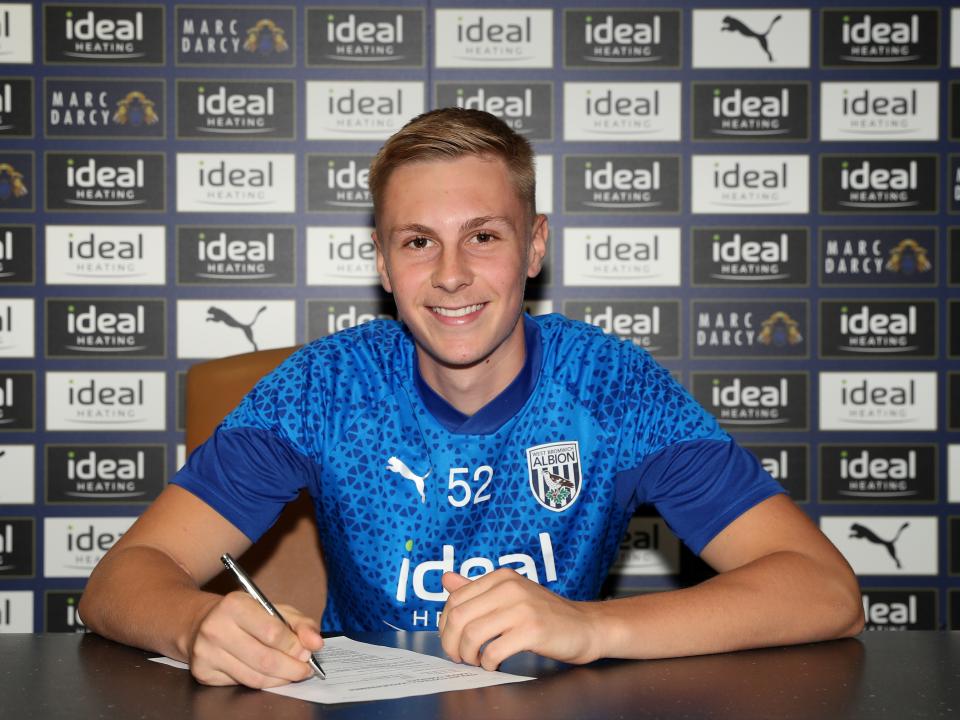 A photo of Layton Love signing his first professional contract