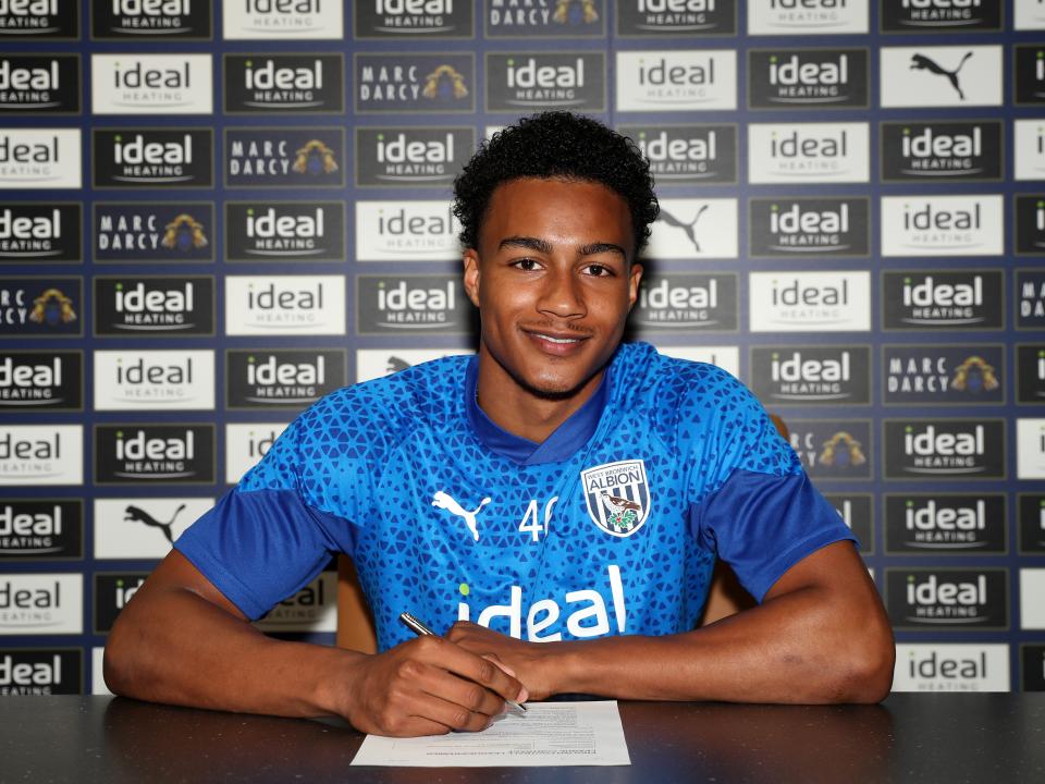 A photo of Narel Phillips signing his first professional contract