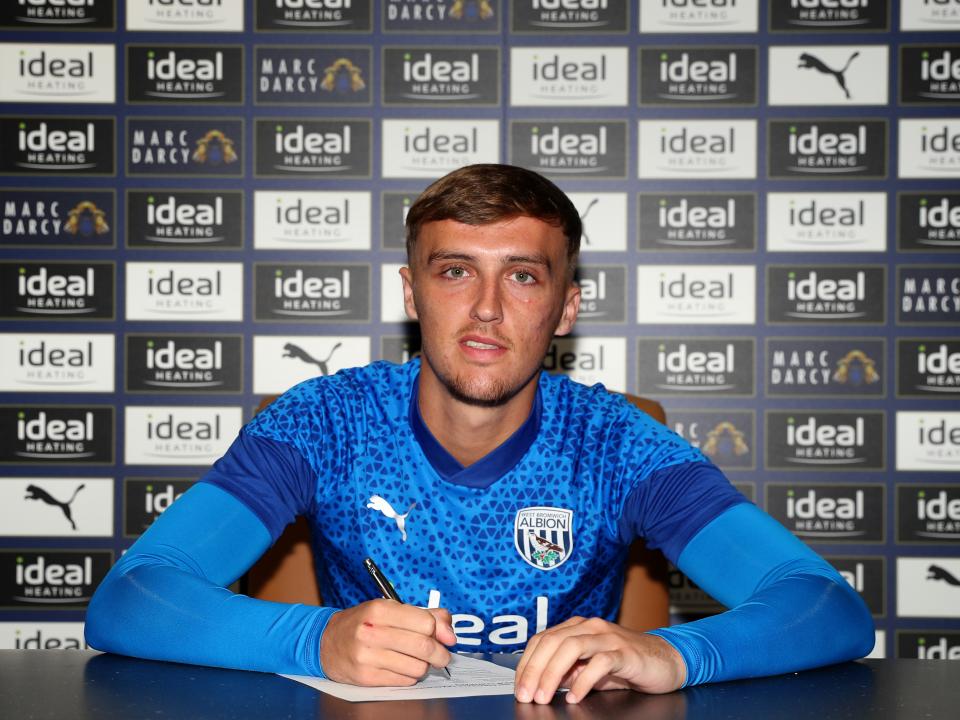 A photo of academy graduate Jamie Andrews signing a one-year extension to his professional deal