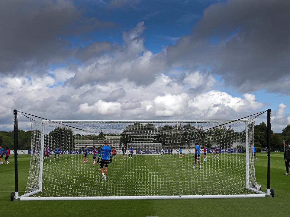 The training goal net with several Albion players behind it