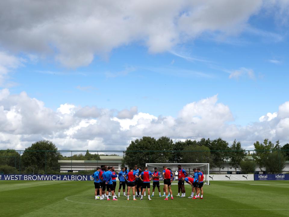 The players in a huddle on the training pitch