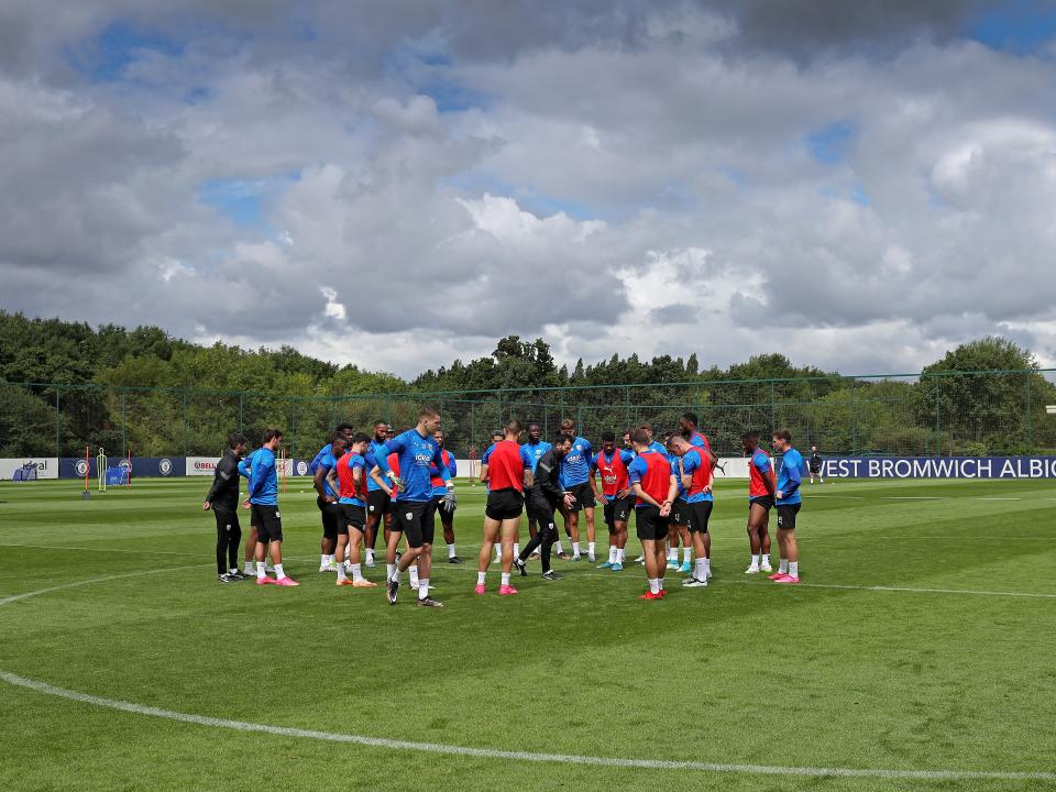 The players in a huddle on the training pitch