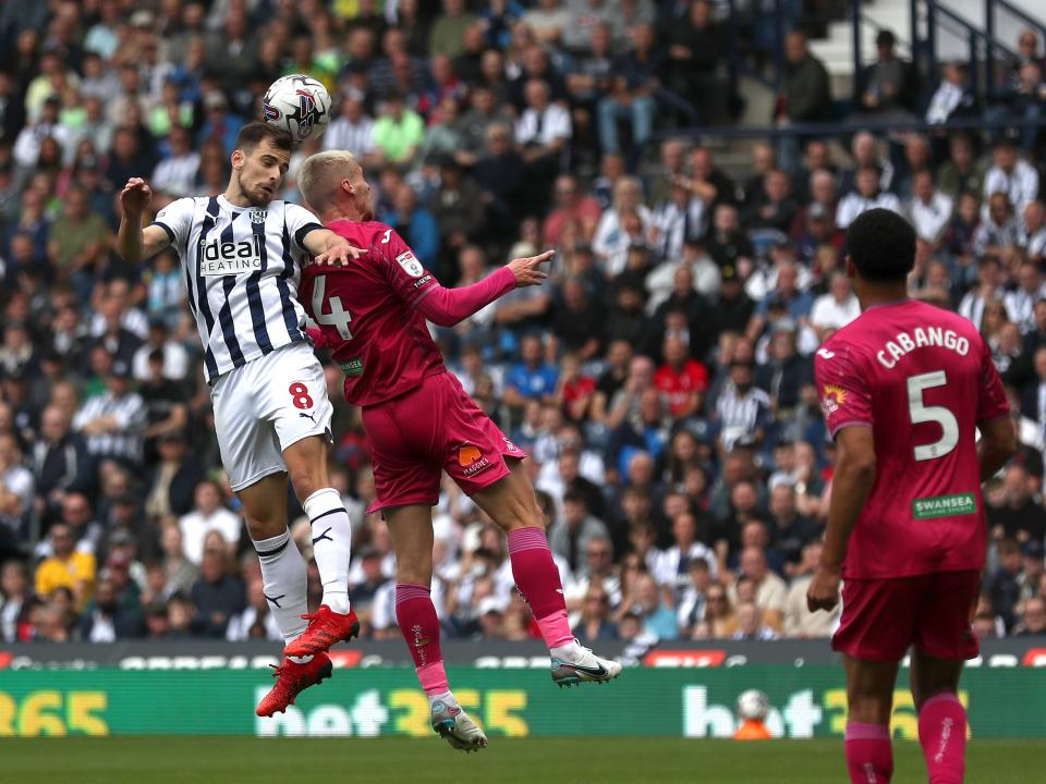 Jayson Molumby jumps for the ball against Swansea 