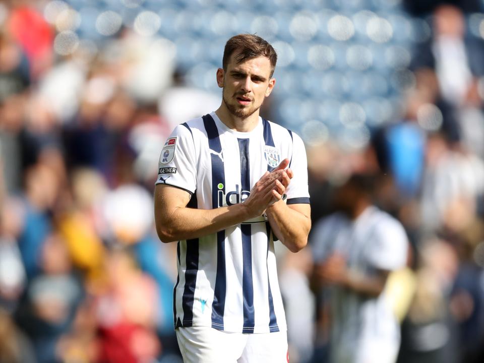 Jayson Molumby applauds the fans at full time