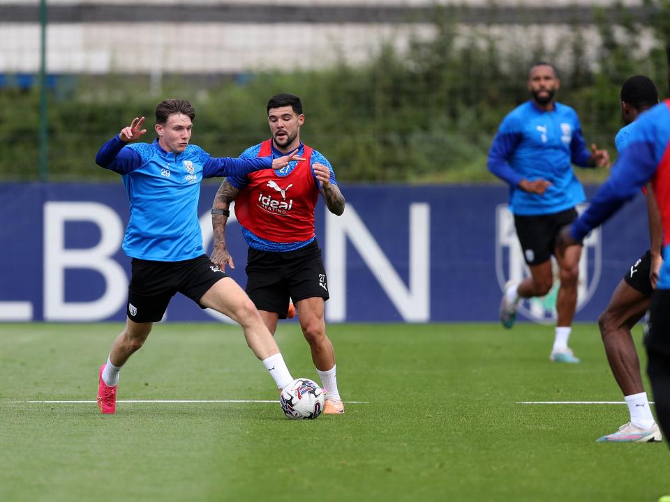 Taylor Gardner-Hickman and Alex Mowatt battle for the ball in training 