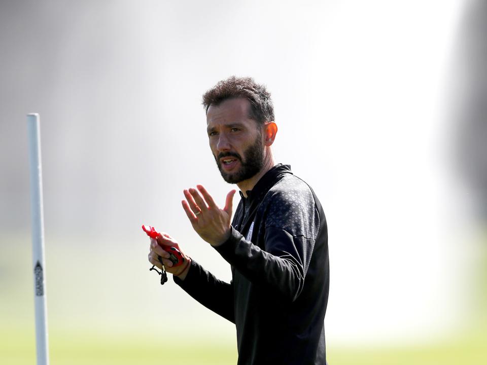 Carlos Corberán in training with water spraying behind him