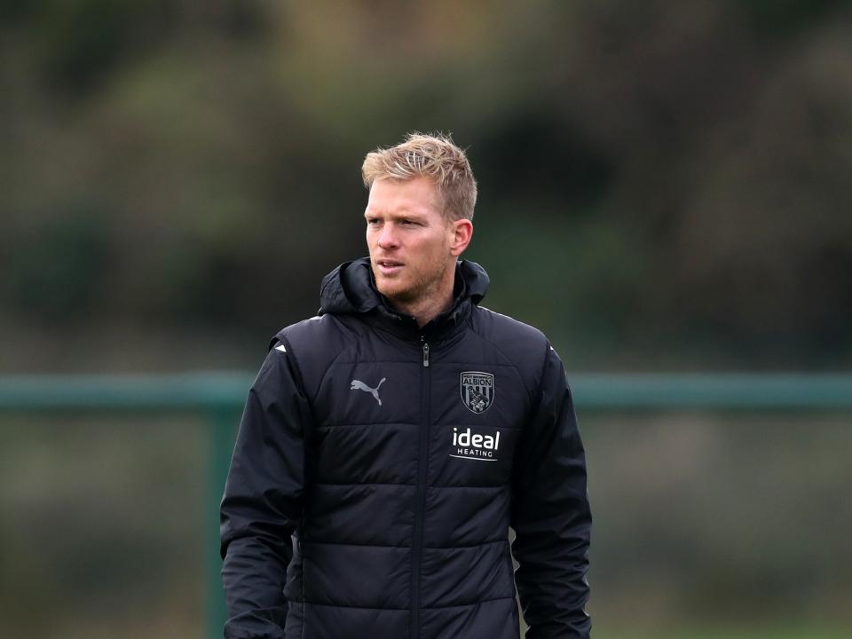U18 coach Leigh Downing wearing a black Albion coat