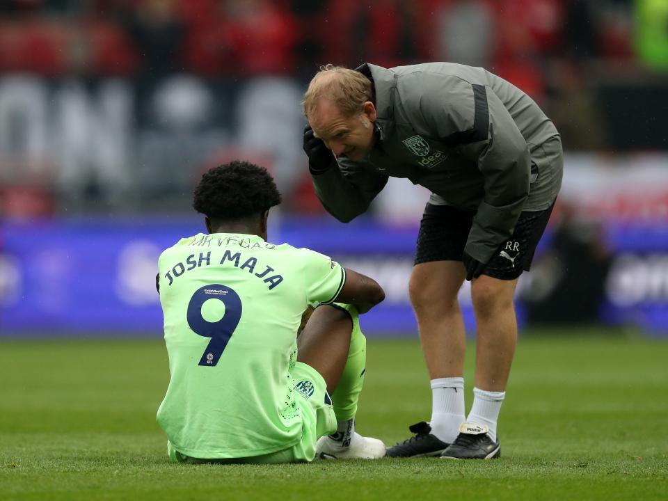 Josh Maja is seen to by physio Richie Rawlins after picking up an injury at Bristol City