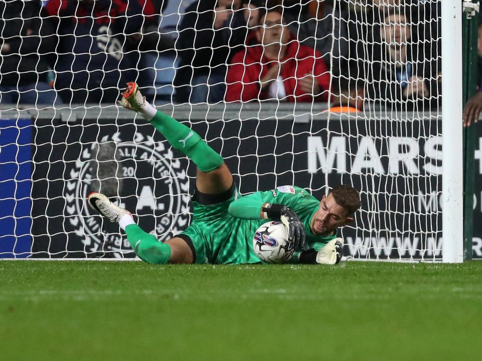 Alex Palmer dives to the floor to collect the ball against Coventry