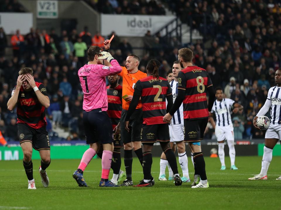 Jimmy Dunne of QPR is shown a red card by the referee 