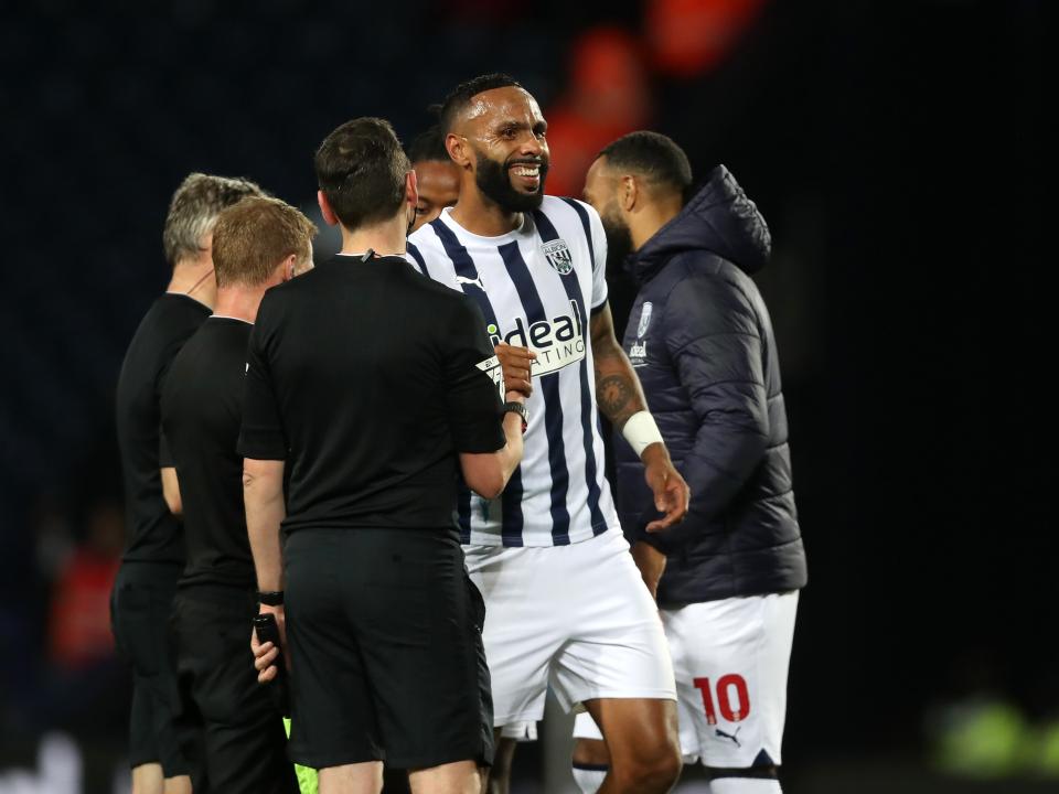 yle Bartley smiling while in conversation with the referee after the whistle