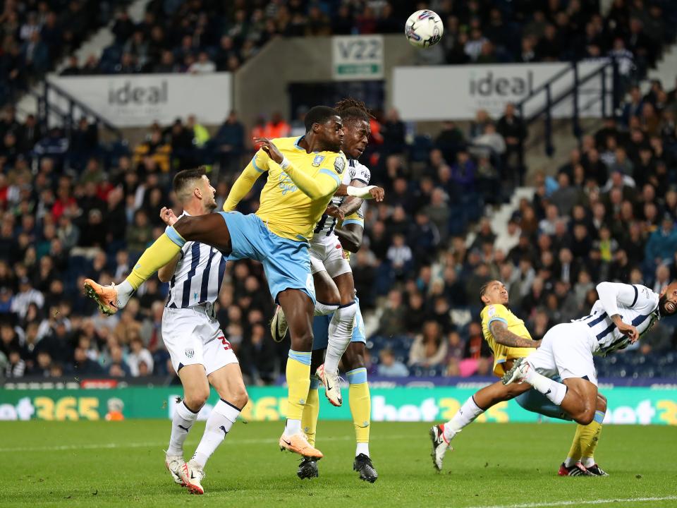 Albion and Sheffield Wednesday players challenge for a high ball