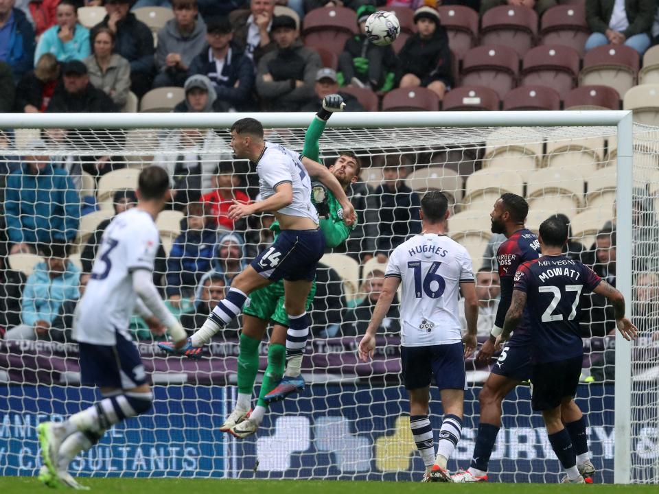 Alex Palmer punches the ball clear against Preston