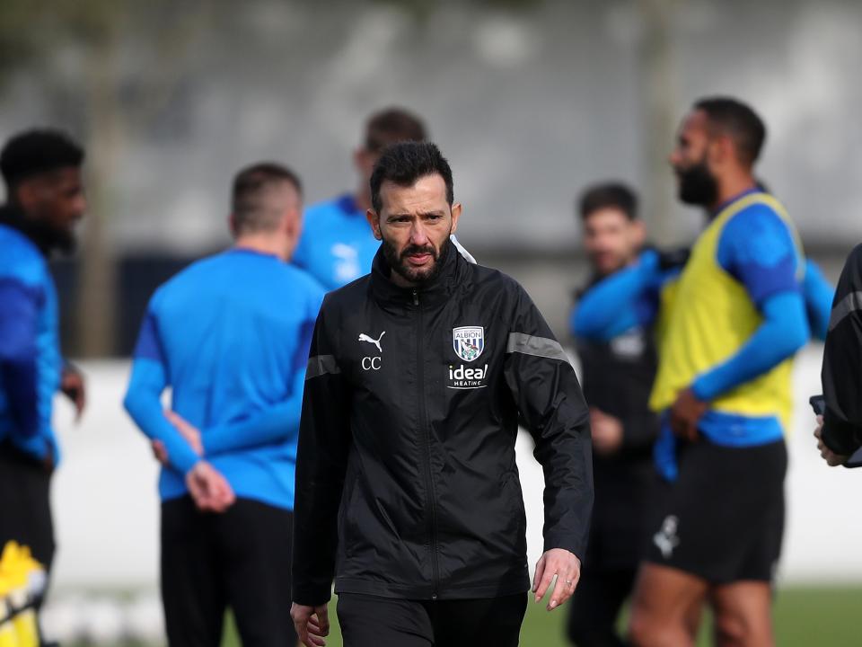 Carlos Corberán in training with players in the background