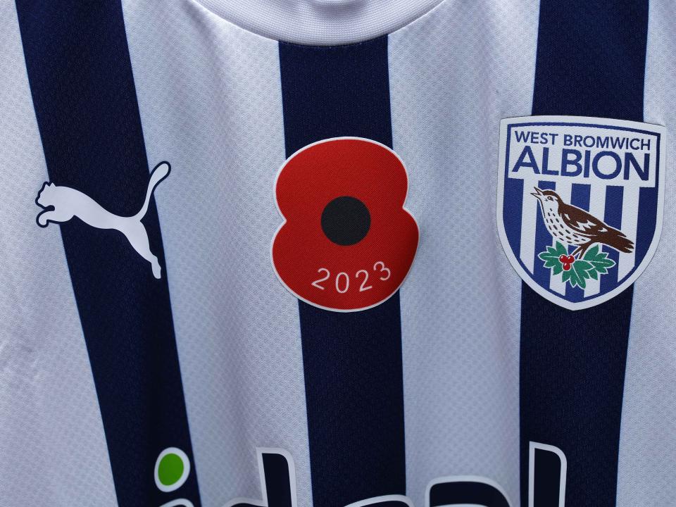 An Albion home shirt featuring a poppy.