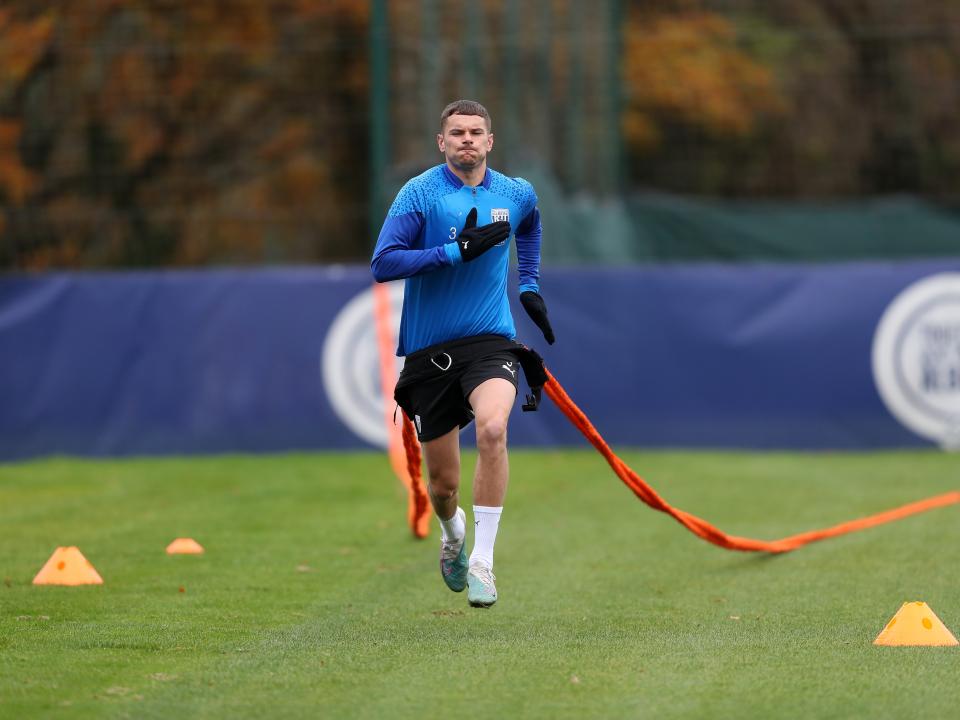 Conor Townsend running with a parachute attached to his back