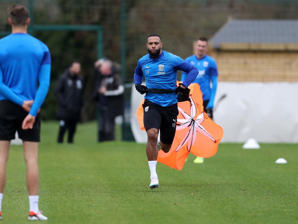 Matty Phillips running with a parachute attached to his back