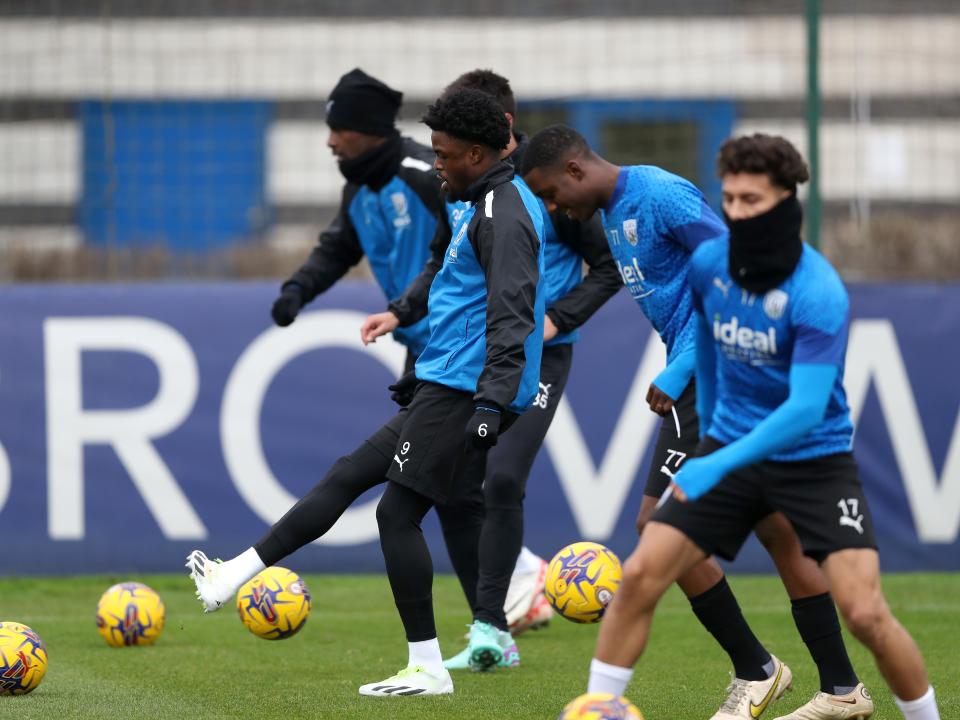 Albion players warming up passing footballs before the training session