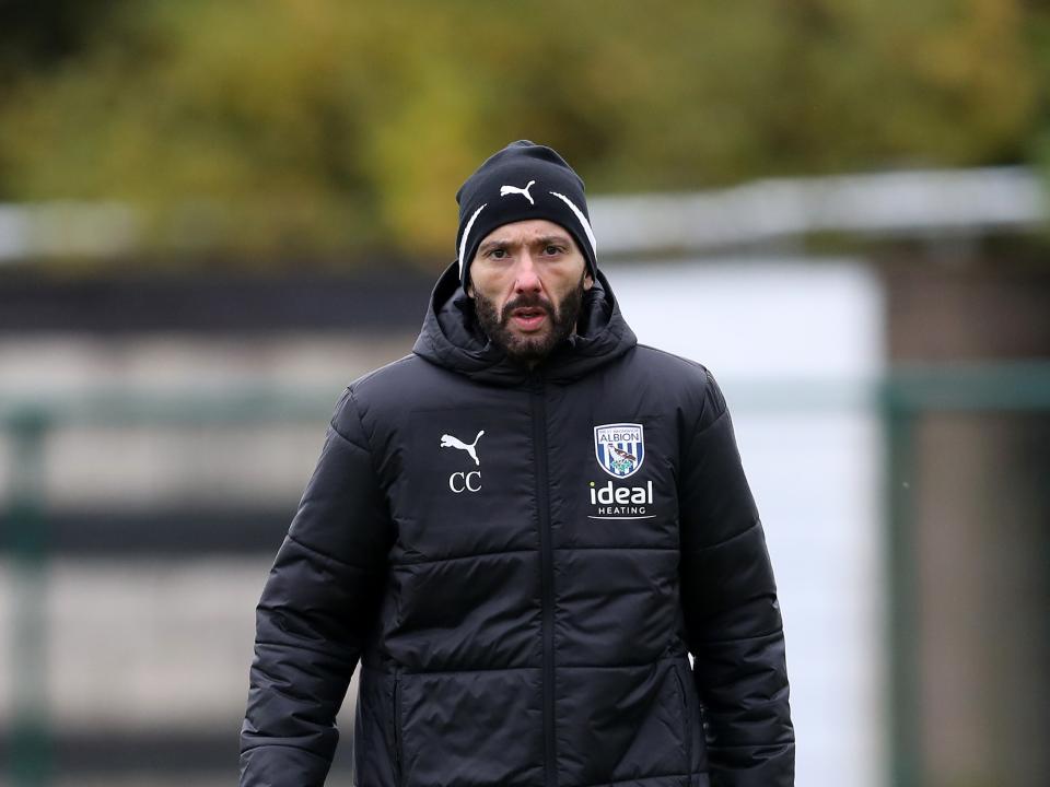 Carlos Corberán looking at the camera with a hat and a coat on