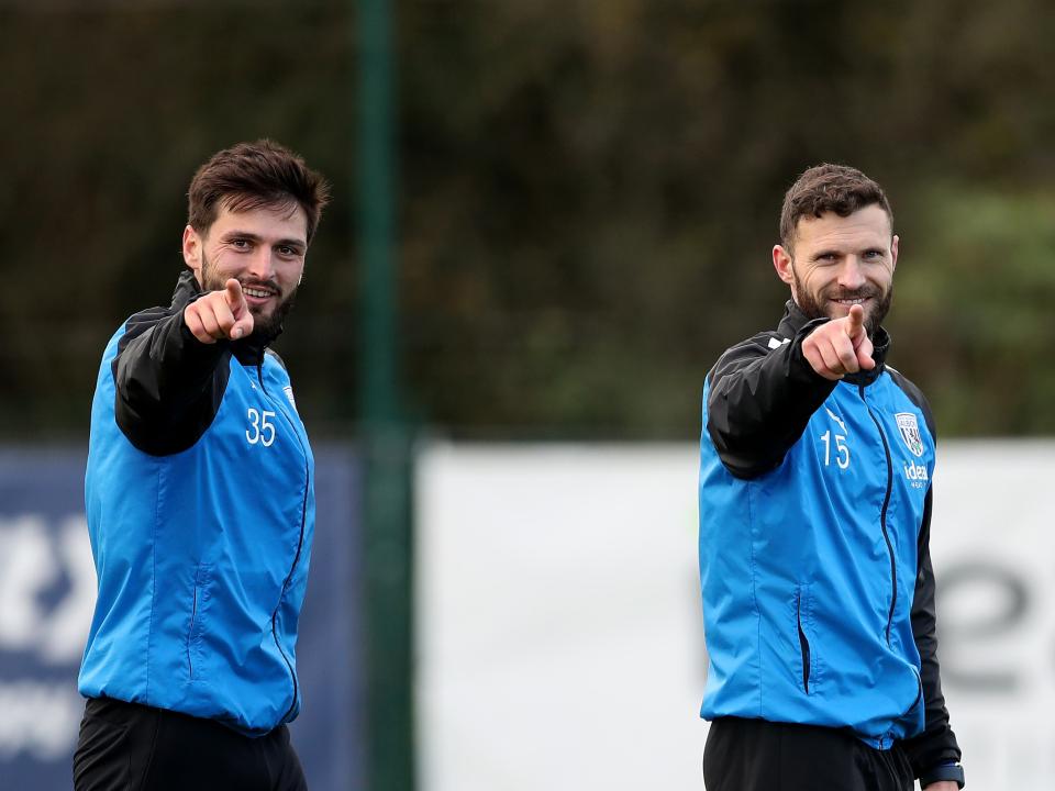 Okay Yokuslu and Erik Pieters point and smile towards the camera