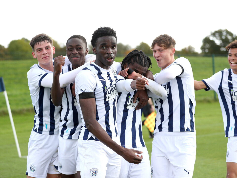 A photo of Albion's U18s celebrating a goal, in the navy blue and white 23/24 home colours, against West Ham