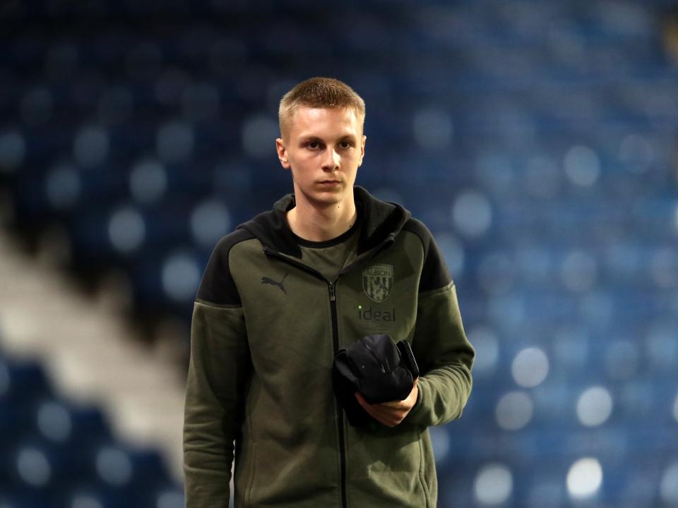 A photo of Layton Love, in green Albion 23/24 tracksuit, arriving for a first team game at The Hawthorns