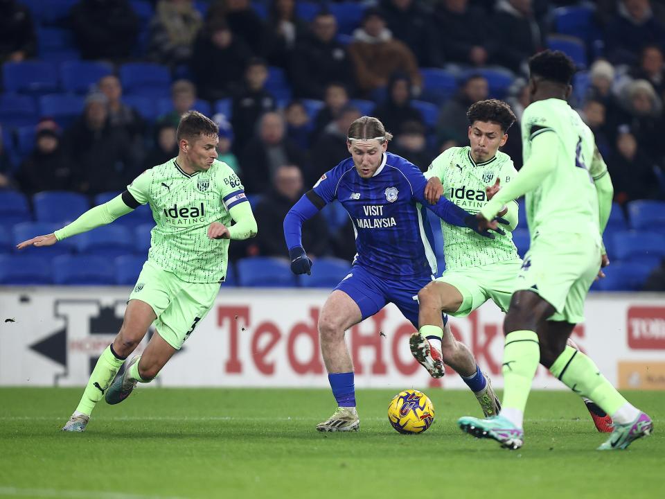 Three Albion players track down a Cardiff attacker