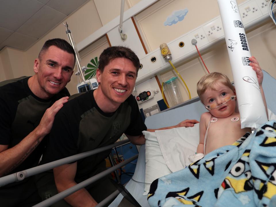 Jed Wallace and Adam Reach meet a young patient at Sandwell General Hospital