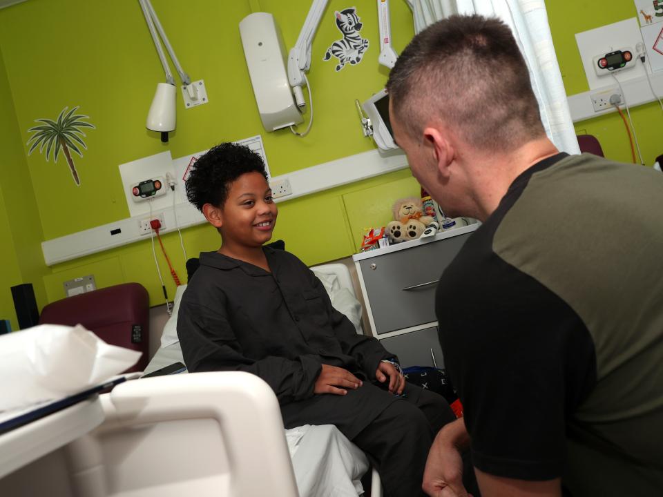 Jed Wallace meets a young patient at Sandwell General Hospital