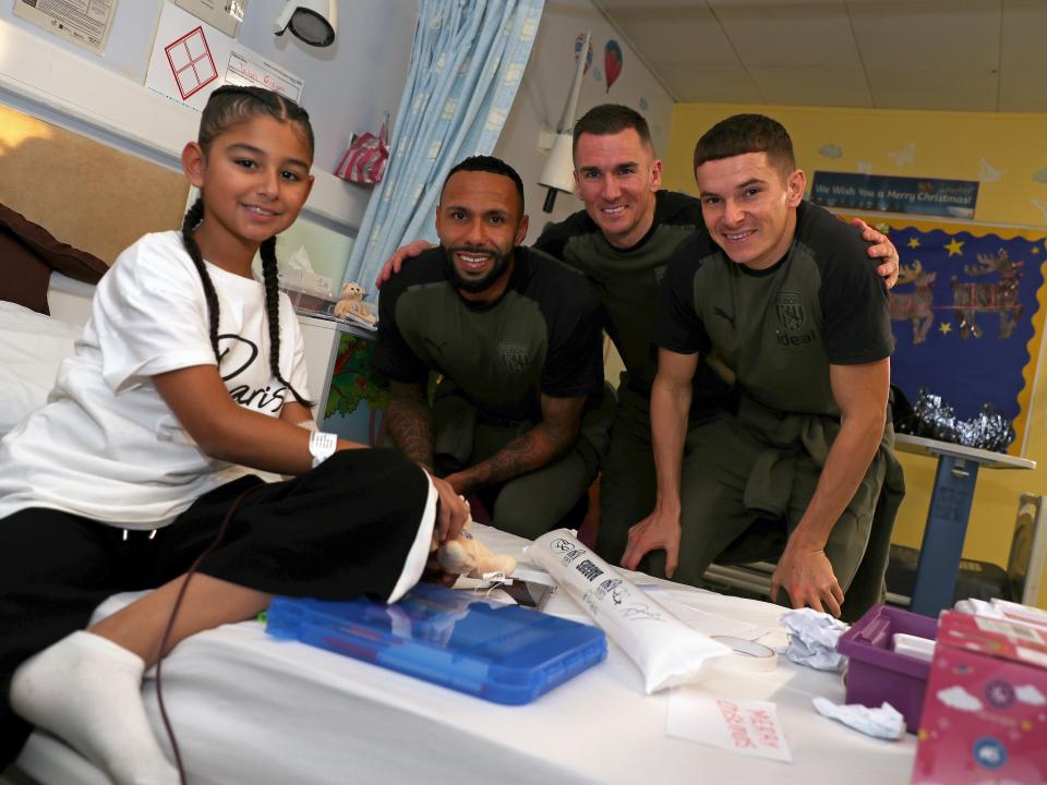 Kyle Bartley, Jed Wallace and Conor Townsend pose for a photo with patients at Sandwell General Hospital