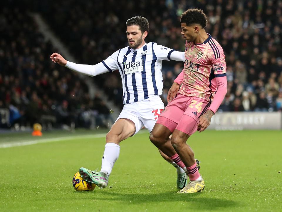 Okay Yokuslu fights for the ball against Leeds