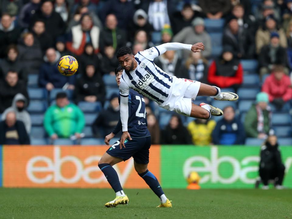 Darnell Furlong flying through the air to head the ball against Stoke