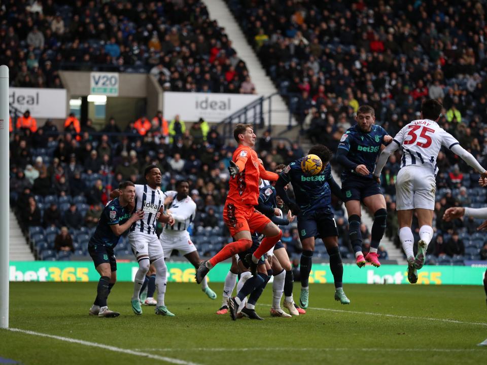 Players from both teams go for the ball in the air in the penalty area