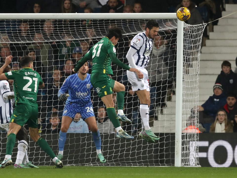 Okay Yokuslu heads the ball away against Norwich