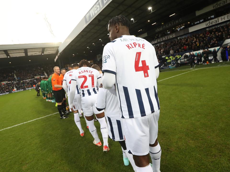 Cedric Kipre with his back to the camera lining up before taking on Norwich
