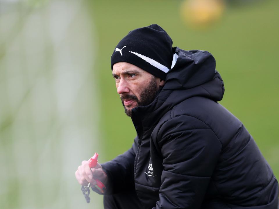Carlos Corberán watches over training