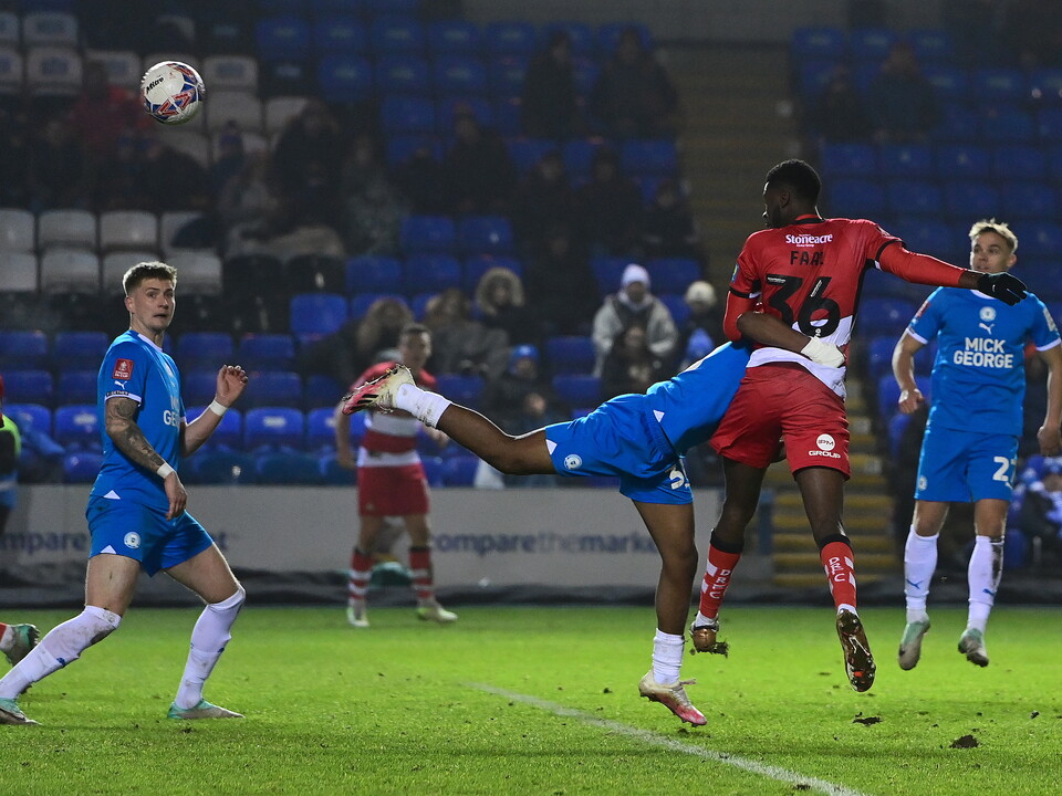 A photo of striker Mo Faal heading in a goal for loan side Doncaster v Peterborough at the Weston Homes Stadium