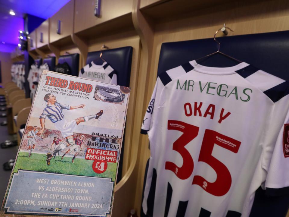 The matchday programme and the back of Okay Yokuslu's shirt in the dressing room before the Aldershot game