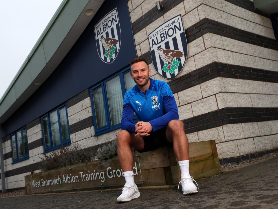 Andi Weimann smiling at the camera while sat outside the training ground