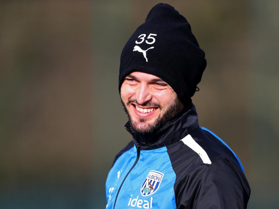 Okay Yokuslu smiling during training wearing a hat