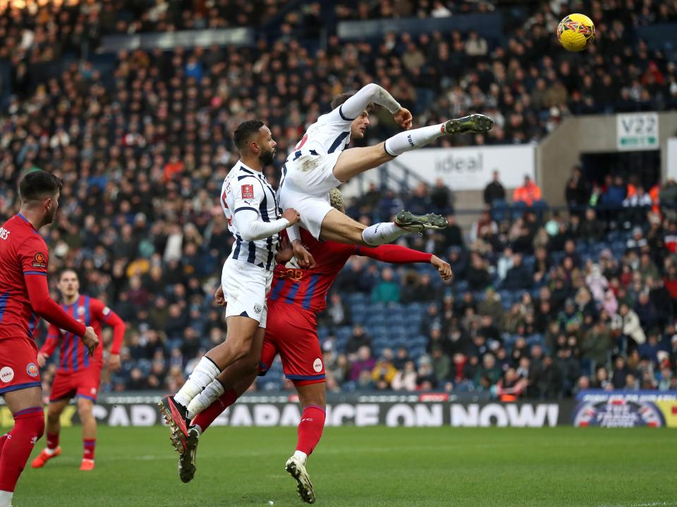 Caleb Taylor jumping high for the ball against Aldershot