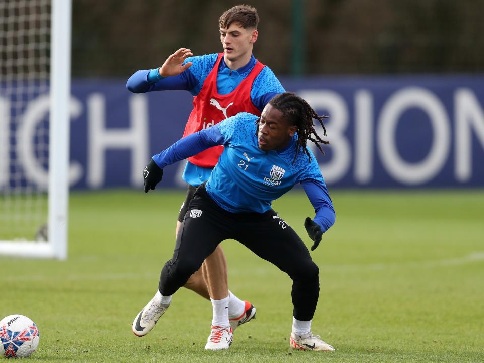 Brandon Thomas-Asante and Caleb Taylor fight for the ball in training 